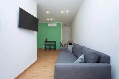 a living room with a couch and a table at Mondello Twentytwo House in Palermo