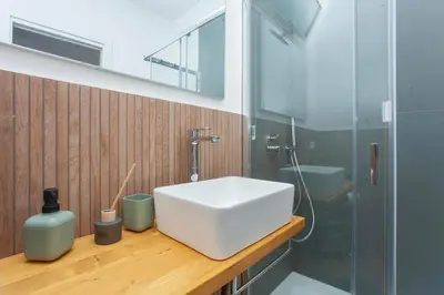 a bathroom with a white sink and a shower at Mondello Twentytwo House in Palermo