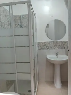 a bathroom with a shower and a sink and a mirror at Casa di Tommy in Palermo