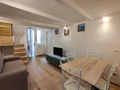 a living room with a table with a laptop on it at Casa di Tommy in Palermo