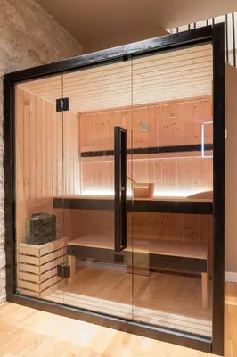 a display cabinet with glass doors in a room at Five suite in Palermo