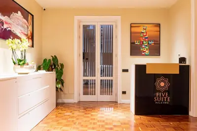a living room with a fire source box in front of a door at Five suite in Palermo