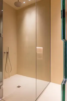 a shower in a bathroom with a glass door at Five suite in Palermo