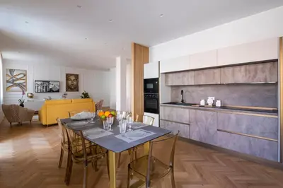 a kitchen and dining room with a table and chairs at Palace Ducrot in Palermo
