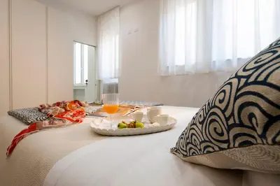 a bed with a tray of food on top of it at Palace Ducrot in Palermo