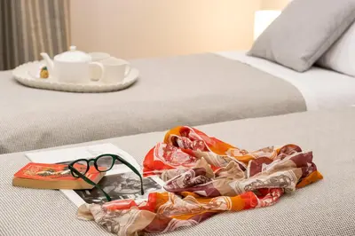 a pair of scissors sitting on top of a bed at Palace Ducrot in Palermo