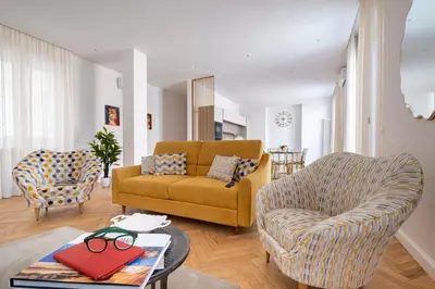 a living room with a couch and a chair at Palace Ducrot in Palermo