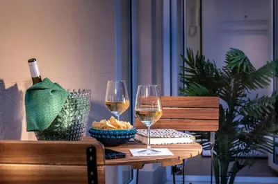 a table with two glasses of wine and a bowl of cheese at Ducrot Apartment in Palermo