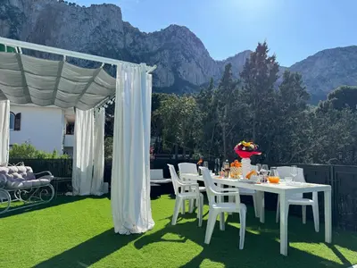 a white table and chairs on a lawn with a tent at Mondello Luxury Apartment in Palermo
