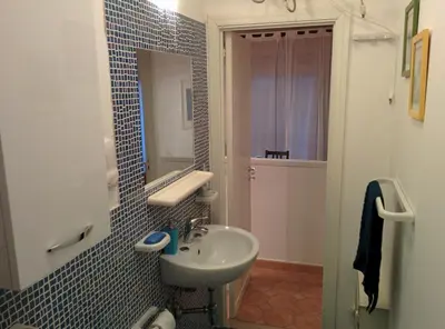 a bathroom with a sink and a mirror at Apartment 