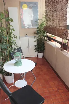 a table and chairs in a room with plants at Apartment 