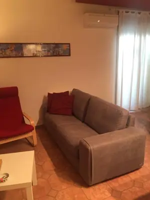 a living room with a couch and a red chair at Apartment 