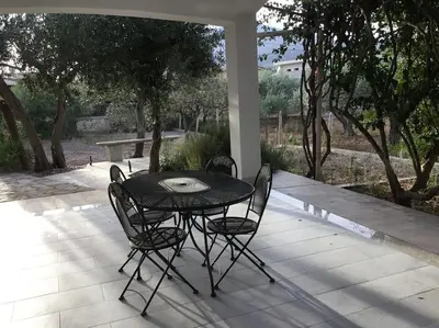 a black table and chairs on a patio at Casa Amuri in Scopello