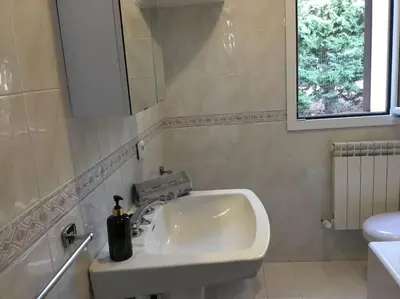 a white sink in a bathroom with a window at Casa Amuri in Scopello