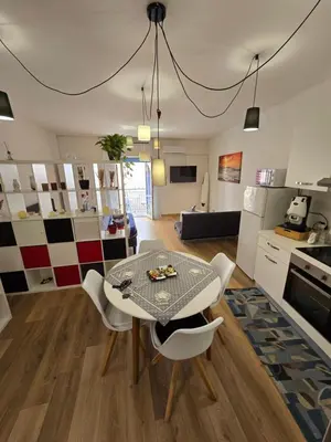 a kitchen and living room with a table and chairs at Virginia House1 in Palermo