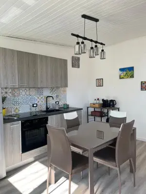 a kitchen and dining room with a table and chairs at Le Terrazze di Chiara in Palermo