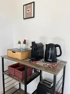 a table with a toaster and a coffee maker on it at Le Terrazze di Chiara in Palermo
