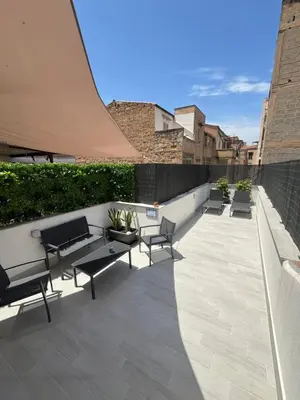 a patio with benches and tables on a building at Le Terrazze di Chiara in Palermo