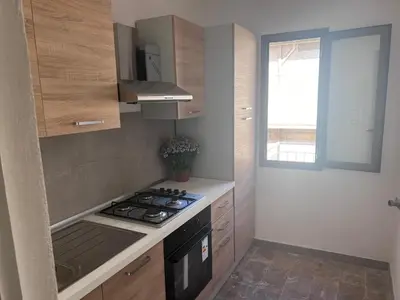a small kitchen with a stove and a window at Casa di Pippo in Trappeto