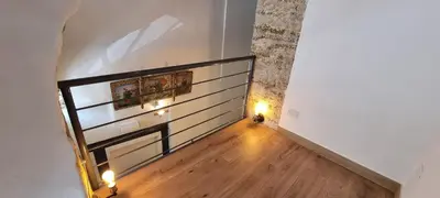 an empty hallway with a staircase with lights on the wall at Le Antiche Porte in Palermo