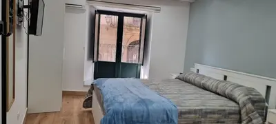 a bedroom with a bed and a large window at Le Antiche Porte in Palermo