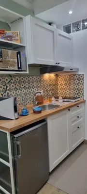 a kitchen with white cabinets and a sink at Le Antiche Porte in Palermo