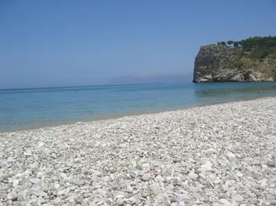 a large group of rocks on a beach near the water at Scopello - Finestra sul cortile in Scopello