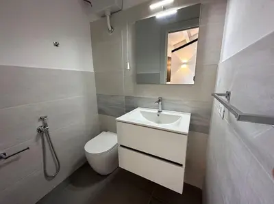 a bathroom with a sink and a toilet and a mirror at Scopello - Finestra sul cortile in Scopello
