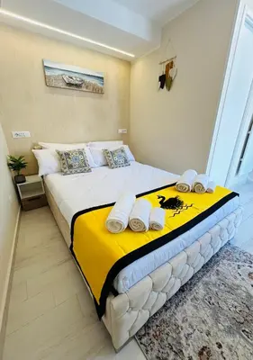a bedroom with a large bed with towels on it at Gioiamia Luxury Apartment in Palermo