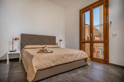 a bedroom with a bed with a tray of food on it at Casa del Golfo Cascio in Castellammare del Golfo