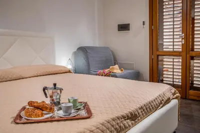 a bed with a tray of pastries on it at Casa del Golfo Cascio in Castellammare del Golfo