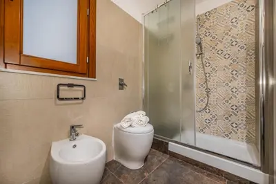a bathroom with a toilet and a sink and a shower at Casa del Golfo Cascio in Castellammare del Golfo