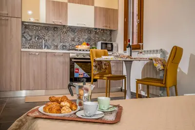 a kitchen with a table with a tray of pastries at Casa del Golfo Cascio in Castellammare del Golfo