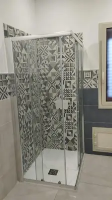 a shower with a glass door in a room at RineddaHouse Arenella - Vista Mare Panoramica a Palermo con Parcheggio privato in Palermo
