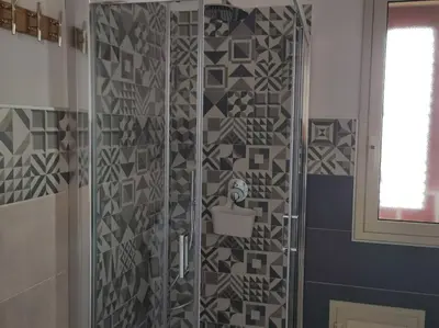 a shower in a bathroom with a tile wall at RineddaHouse Arenella - Vista Mare Panoramica a Palermo con Parcheggio privato in Palermo