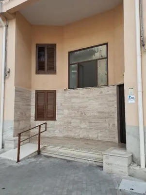 a building with a bench in front of a window at RineddaHouse Arenella - Vista Mare Panoramica a Palermo con Parcheggio privato in Palermo