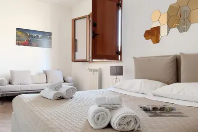 a bedroom with a bed with towels on it at Molo Five Apartment in Palermo