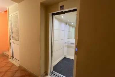 a walk in closet with a sliding glass door at Molo Five Apartment in Palermo