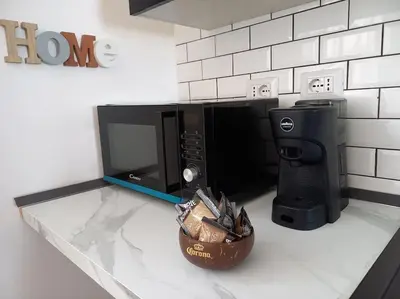 a microwave oven sitting on top of a kitchen counter at Panoramic apartment on the beach A/C in Palermo
