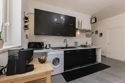a kitchen with a washing machine and a sink at Panoramic apartment on the beach A/C in Palermo