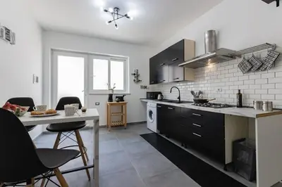 a kitchen with a counter and a table with chairs at Panoramic apartment on the beach A/C in Palermo