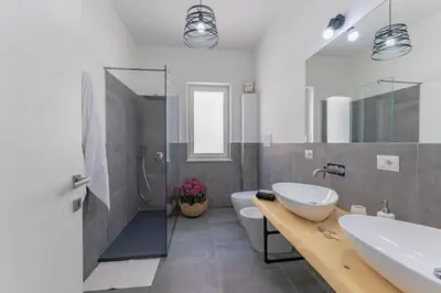 a bathroom with a sink and a toilet and a shower at Panoramic apartment on the beach A/C in Palermo