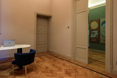 a room with a table and a chair and a door at Belmonte LR Collection in Palermo