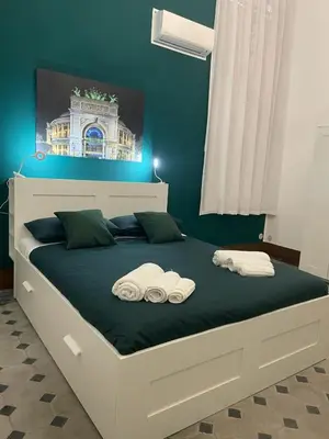 a bedroom with a bed with two towels on it at Ai Crociferi affittacamere in Palermo