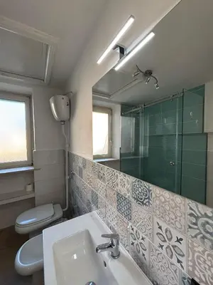 a bathroom with a sink and a toilet and a mirror at Ospiti a casa mia in Palermo