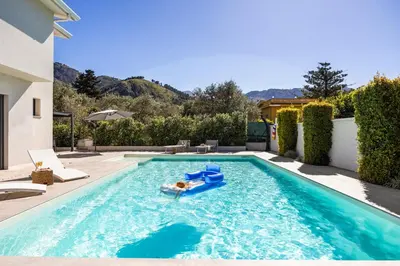 a pool with a person laying on a raft in the water at Luxury villa Taravilla with pool in Altavilla Milicia