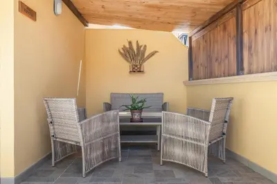 a dining room with wicker chairs and a table at GuestHost - Palermo Charming Flat with Terraces x6 in Palermo