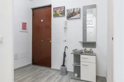 a bathroom with a door and a sink and a mirror at GuestHost - Palermo Charming Flat with Terraces x6 in Palermo