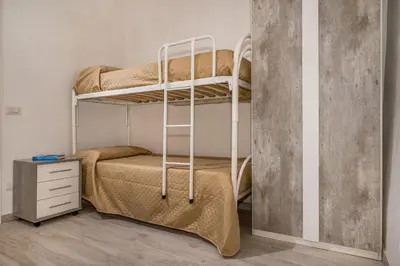 a bedroom with two bunk beds in a room at Casa Del Golfo SantAntonino in Castellammare del Golfo