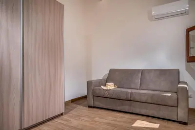 a living room with a brown couch in a room at Casa Del Golfo SantAntonino in Castellammare del Golfo